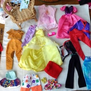 Lot of barbie clothes and additional accessories.